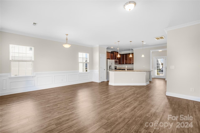 unfurnished living room with ornamental molding, sink, and dark hardwood / wood-style floors