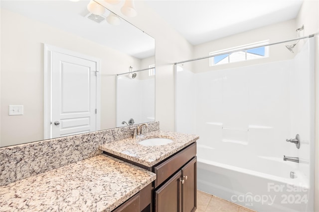 bathroom featuring vanity, shower / bathing tub combination, and tile patterned flooring