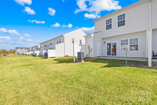 back of property featuring a patio area, a lawn, and central AC unit