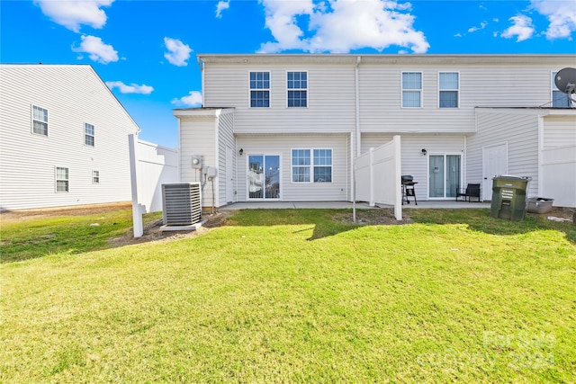 back of property with a patio area, central AC, and a lawn