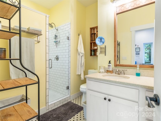 bathroom with vanity, toilet, and an enclosed shower