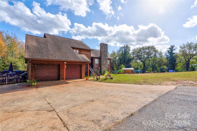 view of front of house featuring a garage and a front lawn