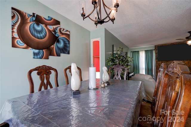 dining area with ceiling fan with notable chandelier and a textured ceiling