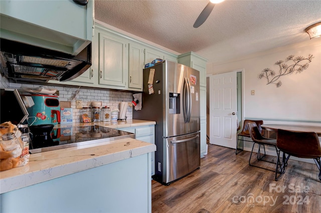 kitchen with extractor fan, a textured ceiling, stainless steel refrigerator with ice dispenser, dark wood-type flooring, and ceiling fan