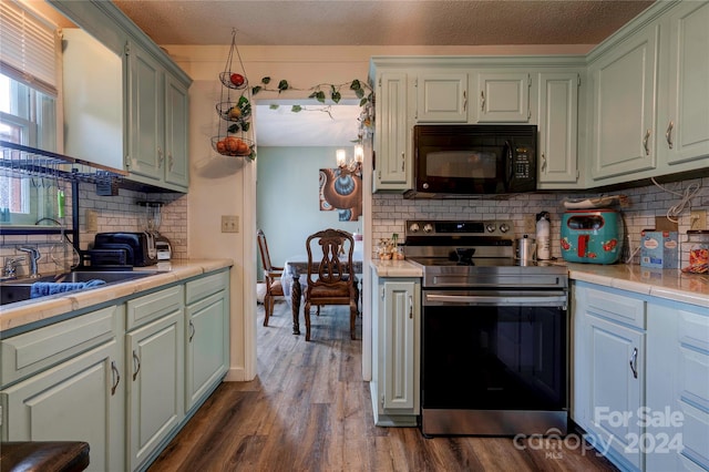 kitchen featuring tasteful backsplash, a textured ceiling, stainless steel electric range oven, sink, and dark wood-type flooring