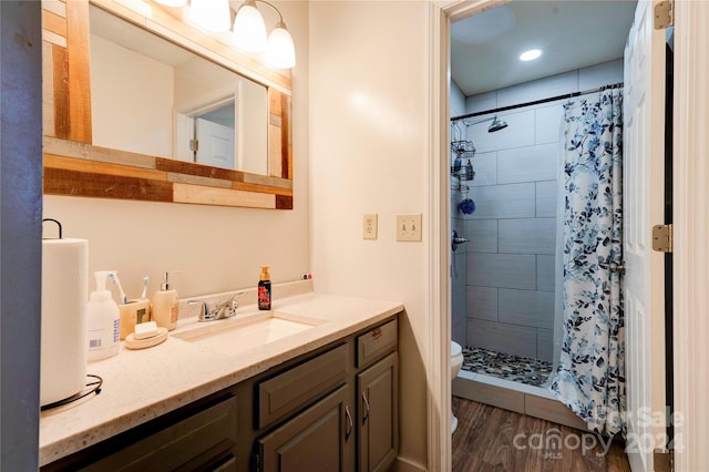 bathroom featuring toilet, a shower with curtain, vanity, and wood-type flooring