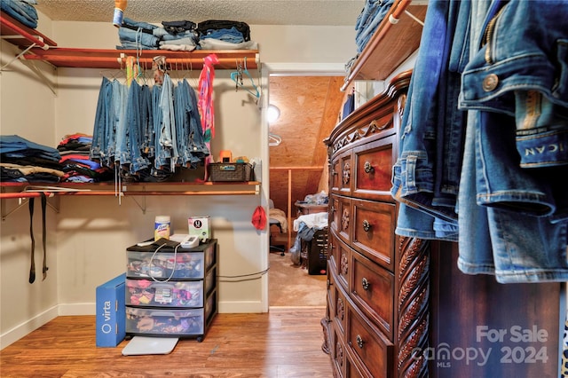 walk in closet with hardwood / wood-style floors