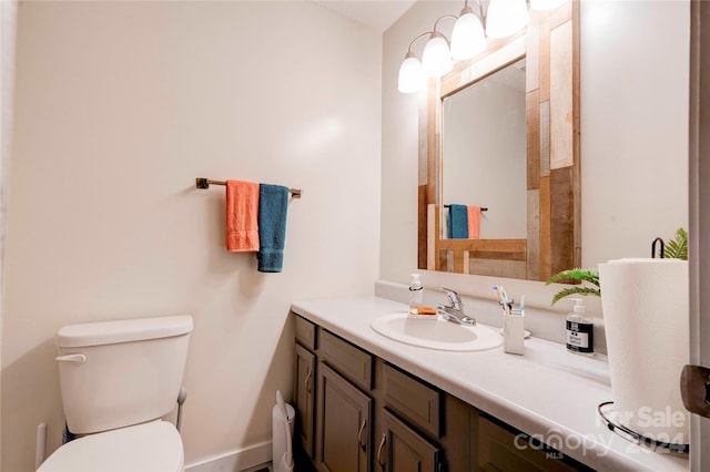 bathroom featuring toilet and vanity