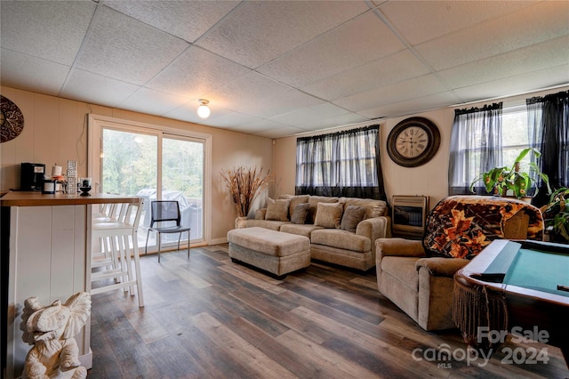 living room featuring hardwood / wood-style flooring, heating unit, billiards, and a drop ceiling