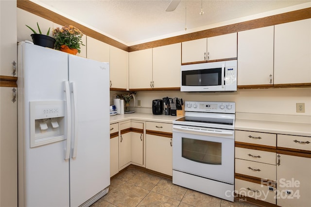 kitchen with light tile patterned floors, white cabinets, a textured ceiling, white appliances, and ceiling fan