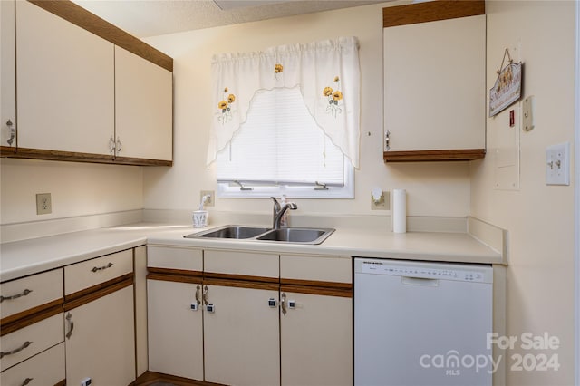 kitchen featuring white cabinetry, sink, white dishwasher, and a textured ceiling