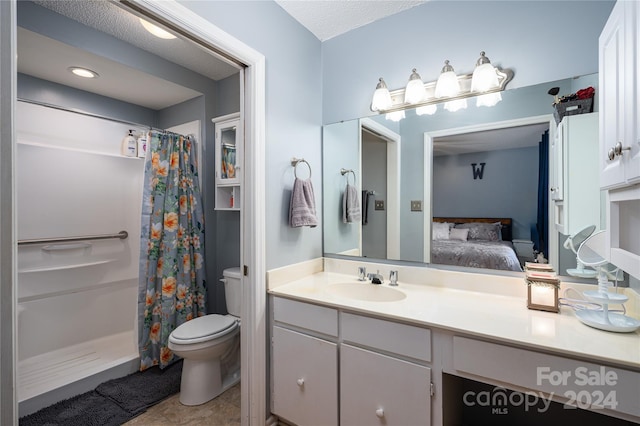 bathroom featuring toilet, tile patterned flooring, a shower with shower curtain, vanity, and a textured ceiling