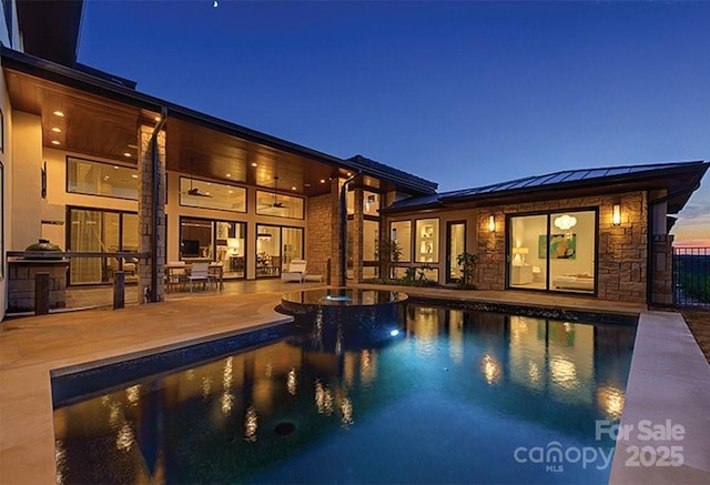 view of swimming pool with a patio and a pool with connected hot tub