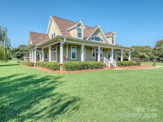 view of front facade featuring covered porch and a front lawn