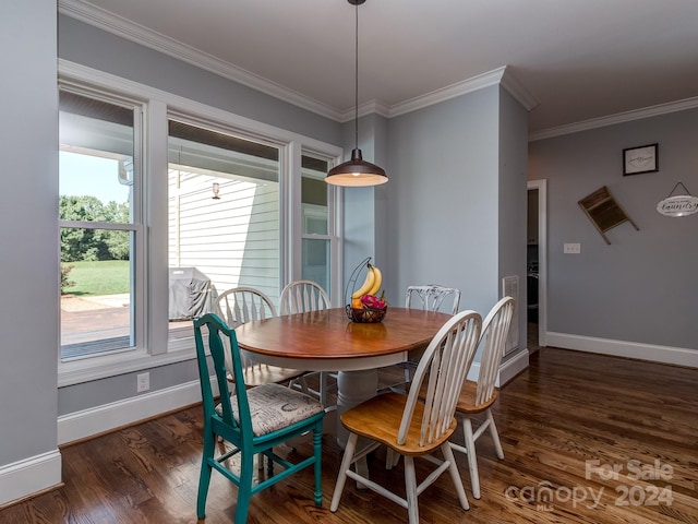 dining area with ornamental molding and dark hardwood / wood-style floors