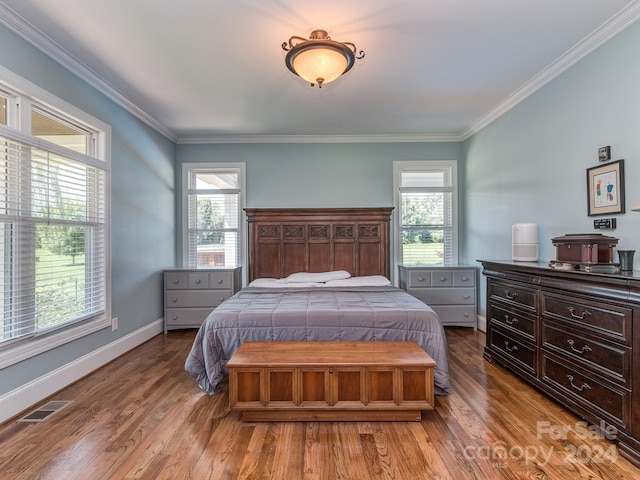 bedroom featuring hardwood / wood-style flooring and multiple windows