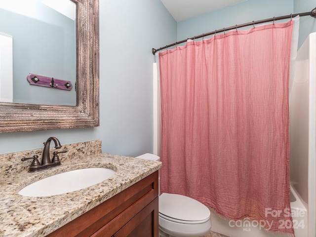 full bathroom featuring vanity, shower / bath combination with curtain, and toilet