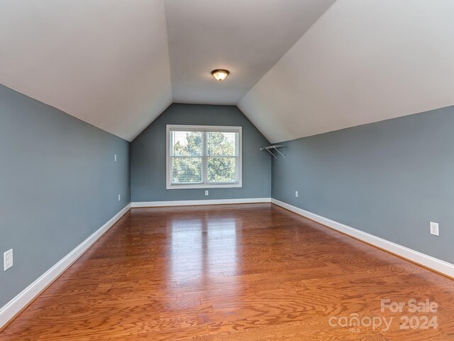 bonus room featuring hardwood / wood-style flooring and vaulted ceiling