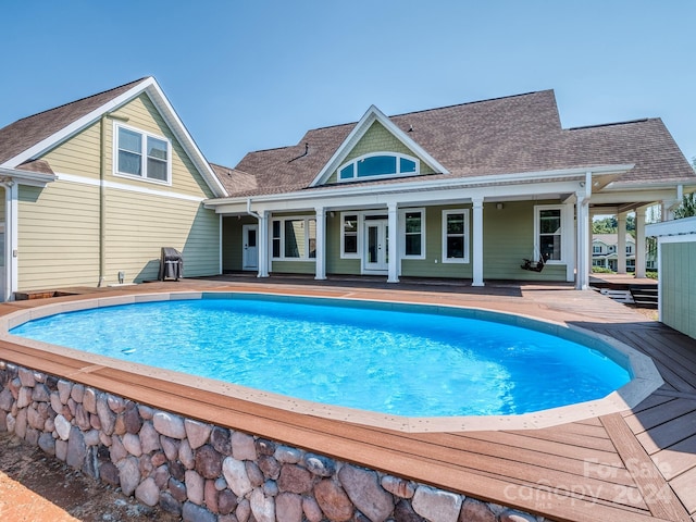 view of swimming pool featuring a deck