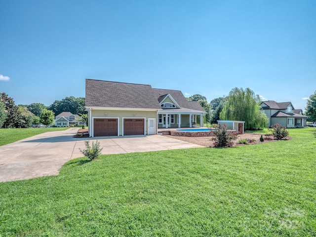 view of front of house featuring a front yard and a garage