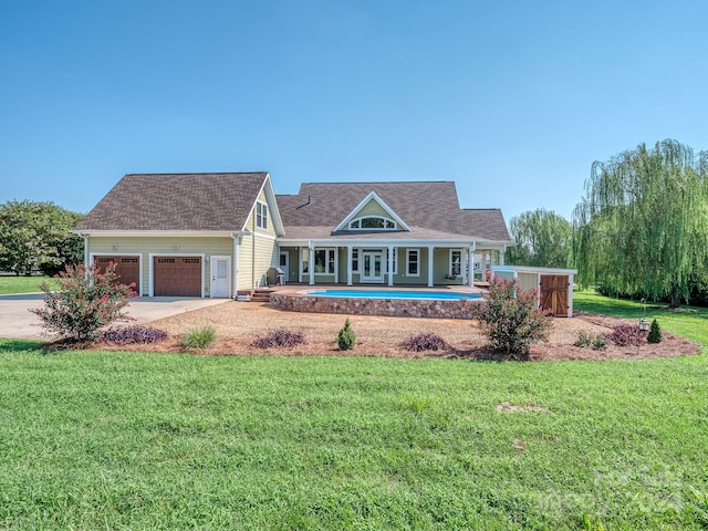 view of front of home with a front yard and a garage