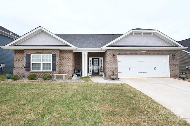 view of front of property with a garage and a front lawn