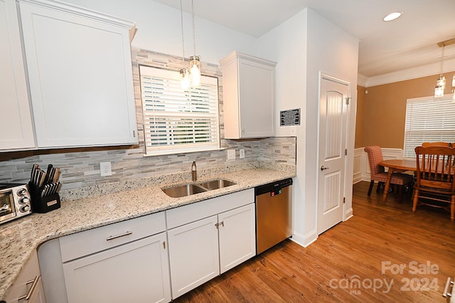 kitchen with white cabinets, light wood-type flooring, dishwasher, decorative light fixtures, and sink