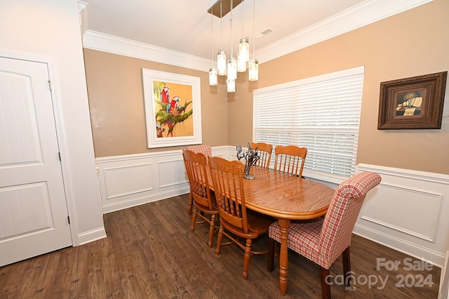 dining room with a notable chandelier, ornamental molding, and dark hardwood / wood-style flooring