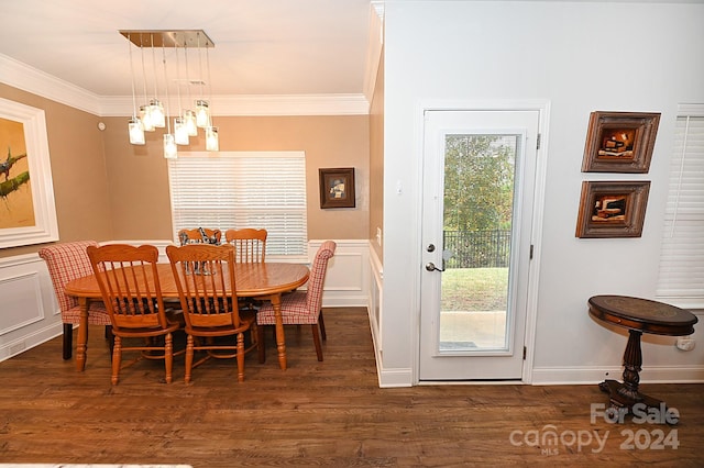 dining space featuring crown molding, a healthy amount of sunlight, and dark wood-type flooring