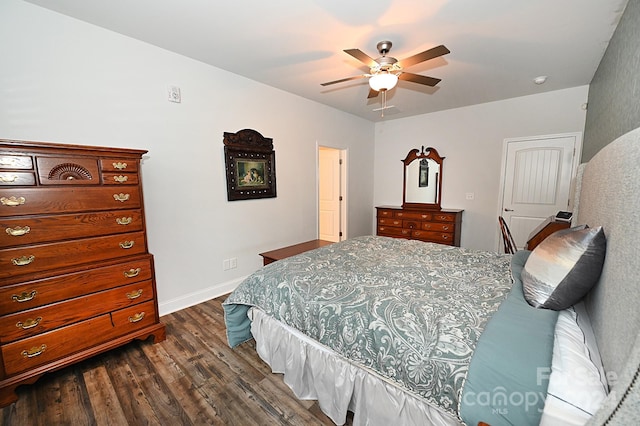 bedroom with ceiling fan and dark hardwood / wood-style floors