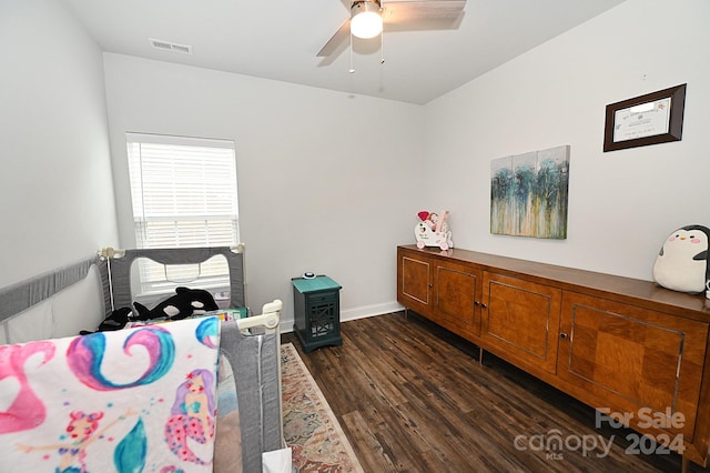 bedroom with dark hardwood / wood-style floors and ceiling fan