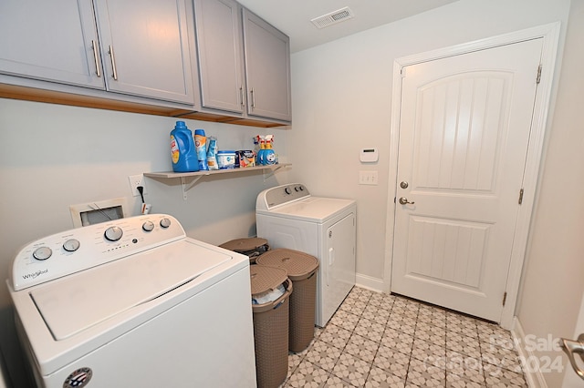 laundry room featuring cabinets and washing machine and clothes dryer