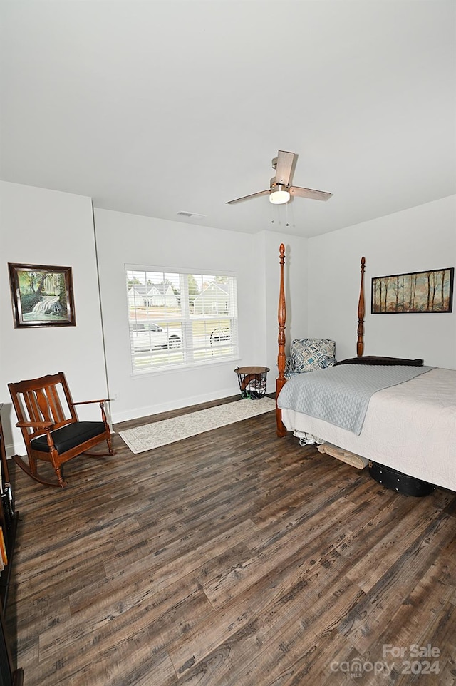 bedroom with dark hardwood / wood-style flooring and ceiling fan