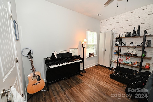 misc room with dark hardwood / wood-style floors and ceiling fan