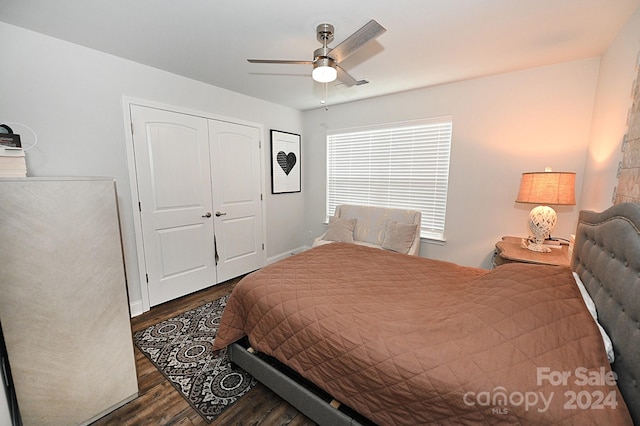 bedroom with a closet, ceiling fan, and dark hardwood / wood-style flooring