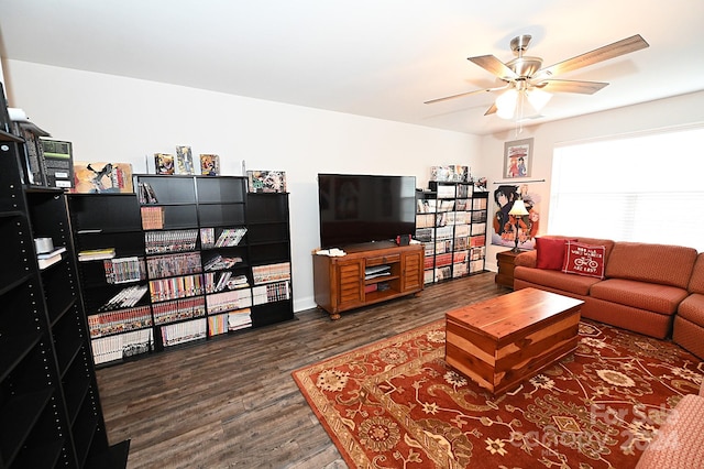 living room featuring ceiling fan and dark hardwood / wood-style flooring