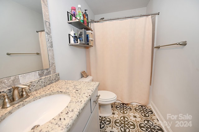 bathroom with vanity, toilet, tile patterned floors, and a shower with curtain