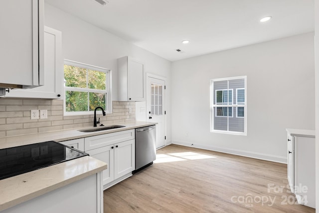 kitchen featuring white cabinetry, light hardwood / wood-style floors, dishwasher, and sink