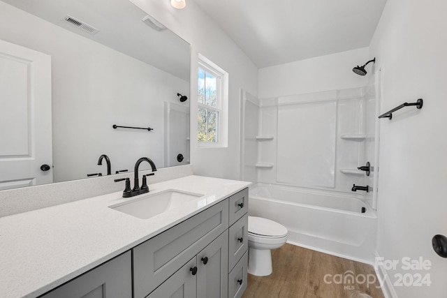 full bathroom featuring vanity, toilet, shower / tub combination, and hardwood / wood-style floors