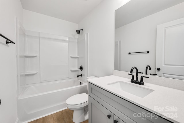 full bathroom with vanity, hardwood / wood-style floors, toilet, and bathing tub / shower combination