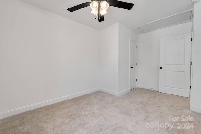 carpeted empty room featuring ceiling fan