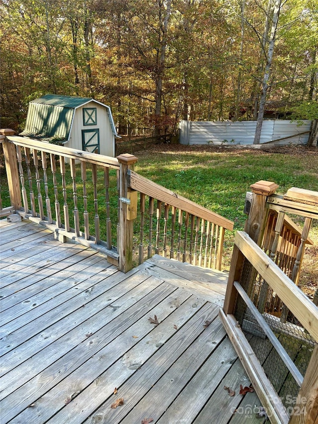 deck with a shed and a yard