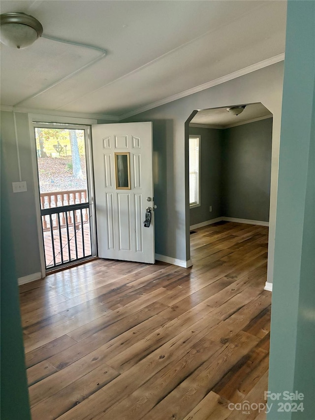 entryway featuring ornamental molding and dark hardwood / wood-style floors