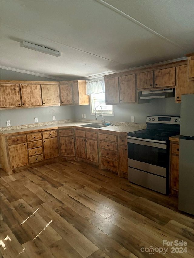 kitchen with dark hardwood / wood-style flooring, sink, vaulted ceiling, and appliances with stainless steel finishes