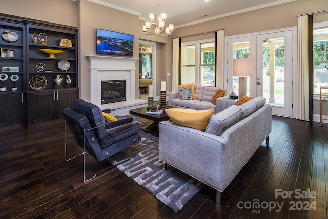 living room with crown molding, dark hardwood / wood-style floors, and an inviting chandelier