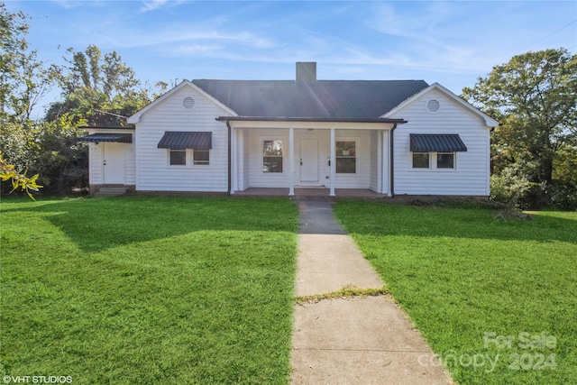 ranch-style home with a porch and a front yard