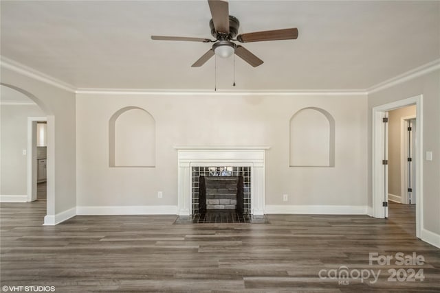 unfurnished living room with crown molding, a fireplace, and dark hardwood / wood-style flooring