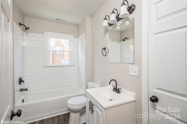 full bathroom featuring vanity, toilet, hardwood / wood-style flooring, and tiled shower / bath