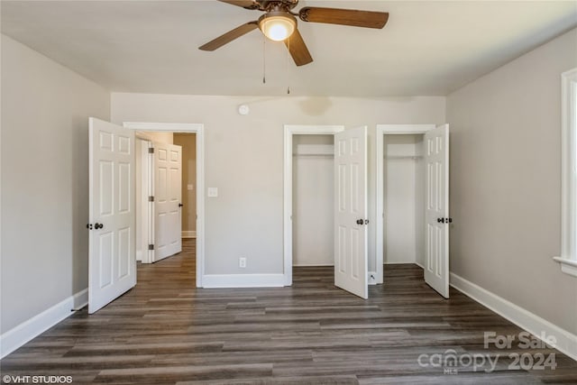 unfurnished bedroom featuring dark wood-type flooring and ceiling fan