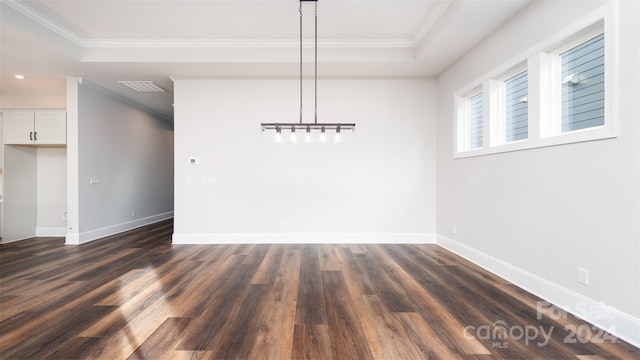 unfurnished dining area featuring a tray ceiling, crown molding, and dark hardwood / wood-style flooring